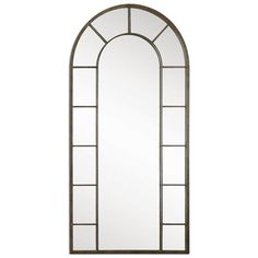 a tall arched mirror sitting on top of a white wall