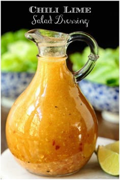 a glass carafe filled with chili lime salad dressing