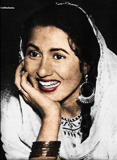 an old black and white photo of a woman with her hand on her chin smiling