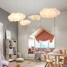 a child's room with wooden flooring and white clouds hanging from the ceiling