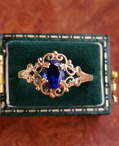 A Gorgeous Solid 14ct Gold Lab Sapphire Cluster Ring, Fully Hallmarked. Vintage from the 1980s Materials: 14ct Gold Gemstone: Lab Sapphire The Sapphire measures 5x7 mm Total Weight: 1.6g Size UK: P Size US: 7 1/2 Condition: Excellent The Ring comes with a set of Full British Hallmarks for authenticity. The pretty ring will arrive beautifully gift wrapped. Please note I'm shipping from the UK. I will post your order in 1-3 working days after confirmed payment, if you need something fast let me kn