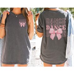 Dance your heart out in style with our "Dance" Shirt featuring a Coquette Bow! 💃🎀 This fashionable and comfortable shirt is perfect for every dancer who loves to add a touch of elegance to their dancewear. Featuring the word "Dance" paired with a cute coquette bow, this shirt is the ideal way to celebrate your passion for dance with flair. 🎨 Vibrant and Trendy Colors: Available in a variety of fashionable colors, this shirt is designed to match your style. Choose your favorite shade and proud Dance Studio Shirts Design, Dance Team Shirts Ideas High Schools, Dance Sister Shirt, Dance Competition Shirts, Dance T Shirts, Dance Shirts Ideas, Dance Team Shirts, Dance Bows, Dancer Shirt