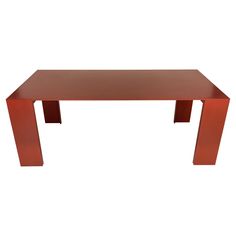 a red table sitting on top of a white floor