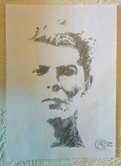 a drawing of a man's face is shown on a piece of white paper