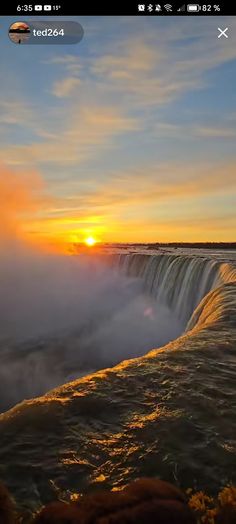 the sun is setting over a large waterfall