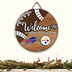 a wooden sign hanging from the side of a wall next to christmas wreaths and decorations