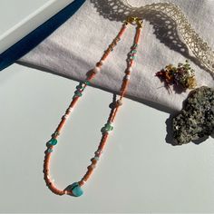 Handmade By Penelope’s Dezines Artisan Jewelry Created To E L E V A T E Your >> Personal Adornment << & A C C E N T U A T E Your >> Natural Beauty << A Coastal Dream. Step Into Your Eternal Summer Era With This Bright And Fresh Necklace. Features Seed Beads In A Vivid Coral Color, With An Intentional Bouncy Pattern Of Teal Blues, White, Sea Foam Green, Gold, And Peachy Pink. Includes Shell, Agate, And Czech Glass. Made With Nylon Coated Stainless Steel Tiger Tail Cord Gold Plated Lobster Clasp A Turquoise Beaded Necklace With Large Beads For Summer, Handmade Pink Necklaces For The Beach, Bohemian Pink Beaded Necklace With Gemstones, Pink Heart Beads Necklace For Beach, Peach Beaded Necklaces With Round Beads As Gift, Pink Beaded Necklaces With Heart Beads For Summer, Summer Pink Beaded Necklace With Heart Beads, Pink Beaded Necklace For Summer Gifts, Pink Heart Beads Necklace For Summer