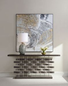 a painting on the wall above a console table