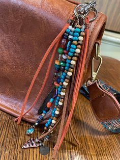 a brown purse with several different beads on it