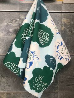 "Marimekko scarf in Pioni print (Peony), Marimekko bandana scarf for women. A beautiful cotton scarf. The material is Marimekko but I have sewn narrow edges with my sweet featherweight.  28\" x 28\", 70 x 70 cm. The scarf features a mod print called Pioni , by Maija Isola in 1970. Stylized flowers in blue and green. Great gift for bridesmaids or maybe your young at heart mom. Other scarves and scarf related items here: https://www.etsy.com/shop/BlueHamster?ref=seller-platform-mcnav&section_id=26 Summer Patterned Printed Silk Scarf, Summer Floral Print Silk Scarf, Floral Patterned Silk Scarf, Summer Floral Print Patterned Scarves, Marimekko Scarf, Green Cotton Fabric With Floral Print, Green Floral Print Cotton Fabric, Mod Print, Foundation Paper Piecing Patterns