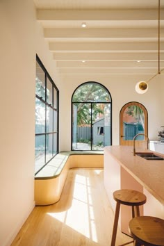 a kitchen with an island counter and two stools