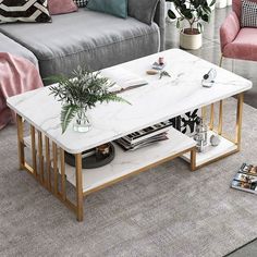 a white marble coffee table in a living room with pink velvet chairs and grey couches