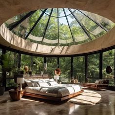 a large bed sitting under a glass dome in a bedroom next to a window filled with trees