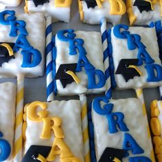 decorated cookies are arranged in the shape of letters and graduation caps