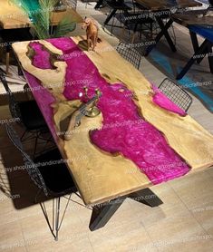 the table is made out of wood and has pink paint on it's surface