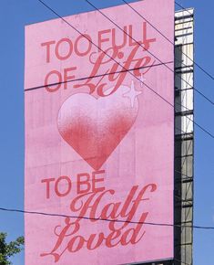 a large pink billboard with a heart on it