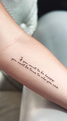 a woman's arm with a tattoo that reads, i am not here and the words are written in cursive font