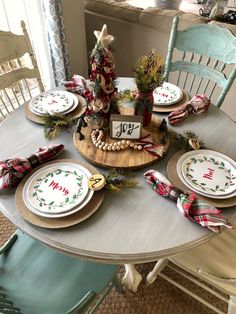 a christmas table setting with plates and napkins