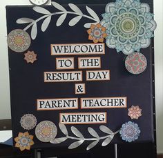 a bulletin board with paper flowers and words written on it that say, welcome to the result day & parent teacher meeting