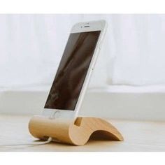 an iphone is sitting on a wooden stand