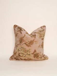 a floral pillow on a white background