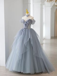 Exude elegance and sophistication in this Smoke Gray Ball Gown Off-The-Shoulder Quinceanera Dress. This dress is crafted from soft tulle fabric that drapes beautifully, while the delicate appliqued embellishments add an intricate touch of artistry and texture. The off-the-shoulder neckline showcases your decolletage with timeless elegance, enhancing the gown's romantic appeal. The smoke gray color lends an air of mystique and sophistication, making this dress truly unforgettable. A sweep train a Beautiful Ball Gowns, Grey Prom Dress, Off Shoulder Evening Dress, Floral Prom Dresses, 파티 드레스, Dress Off Shoulder, Custom Size Dresses, Fairytale Dress, فستان سهرة