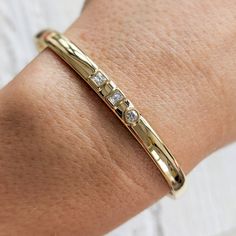 "Our modern 3-stone diamond cuff bracelet features square, emerald and round diamonds set in the middle of a thick, solid gold band. This beautiful bracelet is completely customizable. You can change the diamond shapes, replace diamonds with colored gemstones, change the width, etc. Contact us today with your design idea and for a quote: http://etsy.me/1231fkN Details: - Made at our family-run studio in NYC. - Choose from 14k ,18k (yellow, rose, white Gold) or Platinum. - Solid 14k, 18k yellow, Bracelet With Diamonds, Diamond Cuff Bracelet, Gold Cuff Bracelet, Round Diamond Setting, Indian Jewellery Design Earrings, Solid Gold Band, Big Diamond, Colored Gemstones, White Gold Bracelet