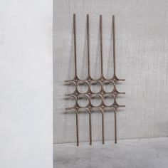 four metal rods are hanging on the wall