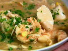 a white bowl filled with soup and shrimp