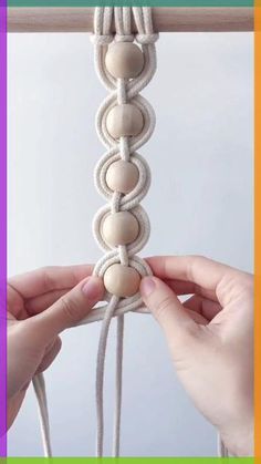 two hands are holding the strings to make a macrame bead bracelet with beads