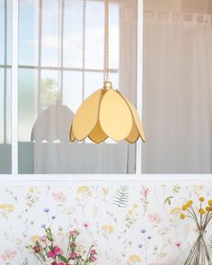 two vases filled with flowers sitting on top of a table next to a window