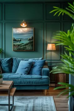 a living room with green walls and blue couches in front of a painting on the wall