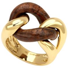 Description: This exquisite groumette ring combines the luxurious appeal of 18 karat yellow gold with the durability and rich texture of rose wood. Known as one of the most resistant and precious woods, rose wood adds a unique and elegant touch to this piece. Part of the iconic Micheletto collection, this ring was originally crafted solely in gold. Over the past decade, the inclusion of wood has become increasingly popular, adding a contemporary twist to the classic design. Material: 18 Karat Ye Luxury Gold-plated Ring With Polished Finish, Unique Luxury Rings In Recycled Gold, Luxury Adjustable Rings With Intricate Design, Luxury Carved Rings As A Gift, Luxury Gold Stamped Ring, Luxury Round Midi Rings As A Gift, Luxury Elegant Ring Jewelry, Luxury Gift Jewelry With Rounded Edges, Luxury Modernist Jewelry For Everyday