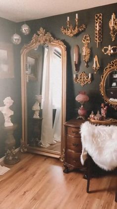 a room filled with furniture and mirrors on the wall, including a dresser and mirror