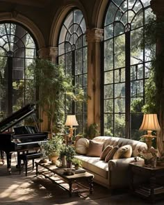 a living room filled with lots of windows and furniture next to a piano in front of a large window