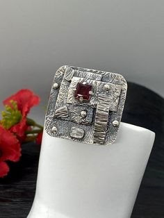 Artisan Art Deco style gemstone ringHand-made Sterling Silver 925size 9-9 1/2Stones used: GarnetFace of the ring:  Height – 27mm, Width-28mm                                        Band height - 5mmUnique Handcrafted One-of a-kind Design RingEach Piece of Jewelry in my Collection is Absolutely One of a Kind!When you start wearing a piece of my jewelry you will fall in love with it more and more each day and feel that good Energy and Love that I pass into it while creating this piece of Art.A piec Unique Ruby Ring With Stone Setting As Gift, Unique Gift Ruby Ring With Stone Setting, Unique Ruby Ring For Anniversary, Modernist Gemstone Ring Jewelry, Modernist Ring Jewelry As Gift, Hand Forged Sterling Silver Ruby Ring, Artisan Sterling Silver Ring With Unique Design, Sterling Silver Modernist Rings For Gifts, Modernist Open Ring Jewelry Gift