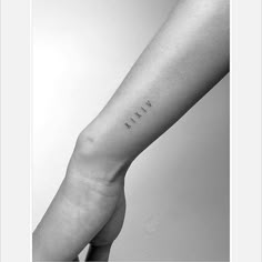 a woman's arm with the word love written on it in cursive font