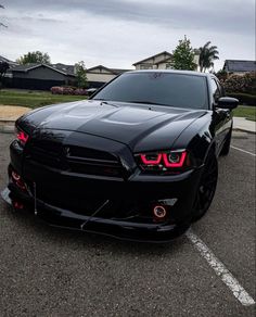 a black sports car parked in a parking lot