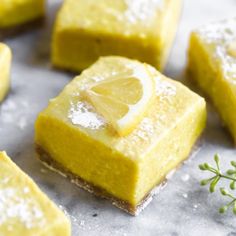 lemon bars with powdered sugar and sprig of thyle on the side