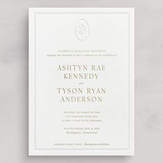 an elegant wedding card with gold foil on the front and bottom, featuring a monogrammed