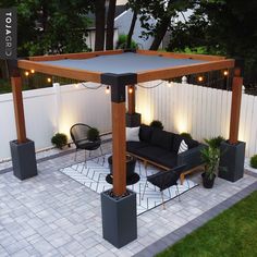 an outdoor living area with black furniture and lights