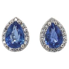 A pair of platinum pear shape stud earrings featuring blue sapphires. The sapphires are a beautiful medium blue color. The pair weighs 1.80 carat total. The sapphires measure about 6.8mm x 4.8mm. There are 28 tiny round diamonds weighing .13cts total and measuring about 1mm. They measure 3/8" long and the pair weighs 2.08dwt. These are new. Clear Sunglasses Frames, Clear Sunglasses, Blue Sapphire Studs, Sapphire Stud Earrings, Aquamarine Studs, Ruby Earrings Studs, Fantasy Cars, Vintage Stud Earrings, Soul Contract