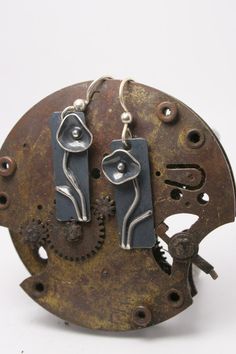 These are hand forged sterling silver earrings. Please email us with any questions.