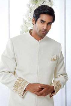 This ivory sherwani set features kiran dori embroidery on the cuffs and a stepper collar detail on a matka silk base. This ensemble is paired with a cotton silk kurta and a stretchable cotton silk trouser. Complimenting footwear is also available.From Seema Gujral's Tuscan Summer collection. DELIVERY TIMEPlease allow 8-12 weeks for your outfit to arrive.FABRIC DETAILSMatka SilkProfessional cleaning only. Ivory Sherwani, Tuscan Summer, Kurta Embroidery, Dori Embroidery, Seema Gujral, Embroidered Sherwani, Vogue India, Silk Kurta, Tarun Tahiliani