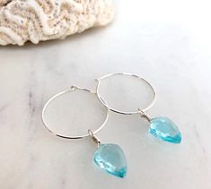 Dainty little aquamarine faceted crystal gemstone hoop earrings in 20mm sterling silver or 14k gold filled hoops. Option for gold plated and silver plated are less expensive. Please see drop down. Perfect for March birthdays! 💙Aquamarine, a stone of serenity, calms and soothes with it's lovely blue/green color and evokes the calm of the water with it's given name, which is interpreted at 'water of the sea' derived from Latin. A stone that celebrates the sea goddess of ancient times, it was carr Sterling Silver Hoop Crystal Earrings For Gift, Small Blue Sterling Silver Hoop Earrings, Blue Sterling Silver Small Hoop Jewelry, Blue Sterling Silver Hoop Jewelry, Blue Hoop Sterling Silver Jewelry, Silver Dangle Hoop Earrings With Birthstone, Blue Hoop Earrings In Sterling Silver, Sterling Silver Gemstone Hoop Earrings, Blue Sterling Silver Hoop Earrings Nickel-free