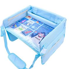 a baby's play table with blue straps and an open book bag on top