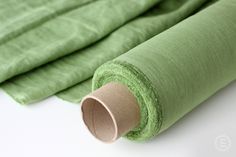 green fabric rolled up on top of each other