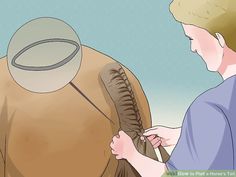 a man is holding an elephant's tail while another person holds it in their hand