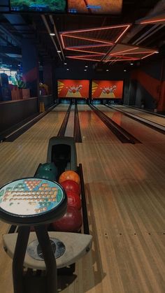 a bowling alley with several bowling balls in it