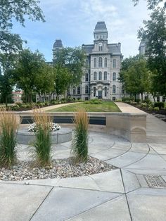 a large building with a fountain in front of it